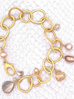 Belmopan Bracelet–Grey Lip Shell, Freshwater Pearls and Golden Shadow Swarovski Crystals enhance this Gem Quality 24K-plated bracelet.