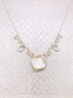 Clear Swarovski Crystals and Freshwater Pearls surrounding a White Keshi Pearl 
